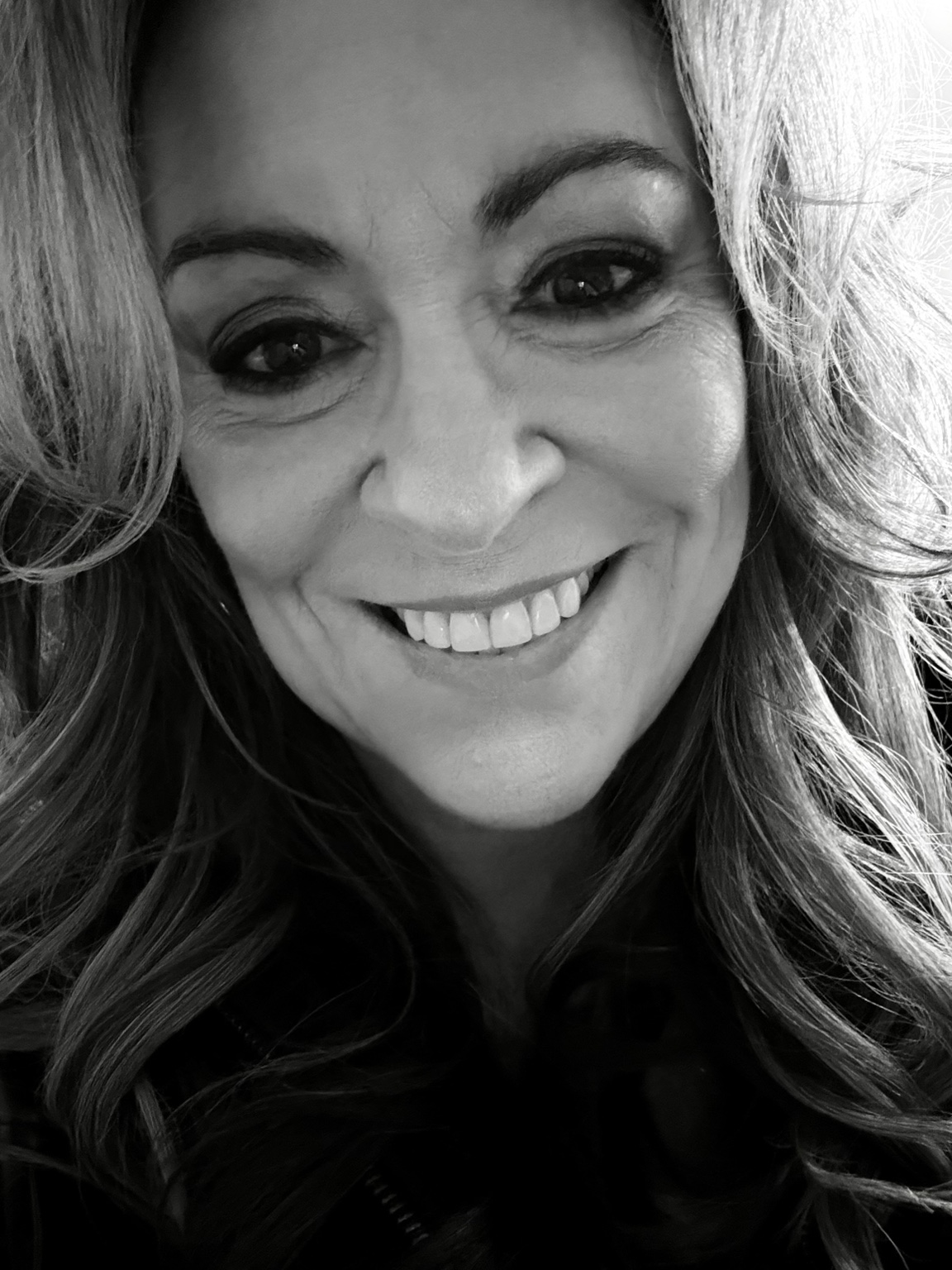 Black-and-white portrait of Amy Barrett smiling